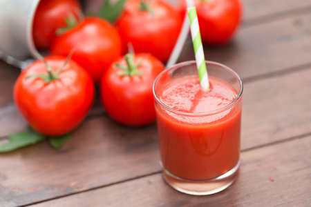 Fresh tomato juice on a wooden backgroundの写真素材