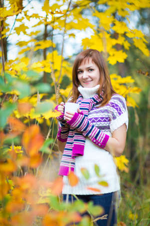 Pretty woman in a colorful autumn parkの写真素材