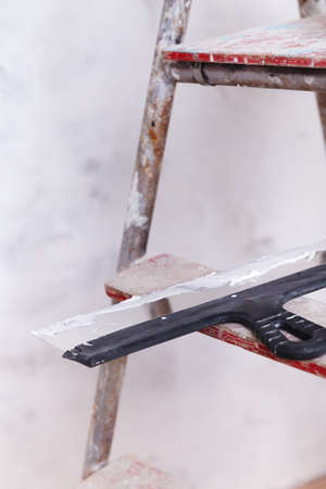 house improvement by worker puts finishing layer of stucco on the wall using a plastering trowelの写真素材