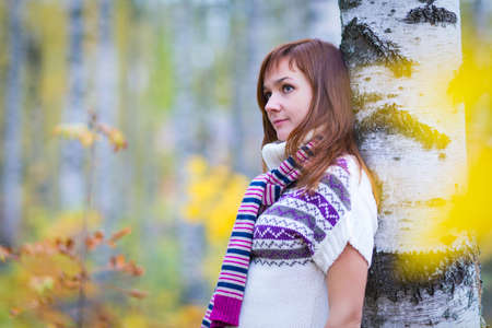 Pretty woman in a bright colorful autumn parkの写真素材
