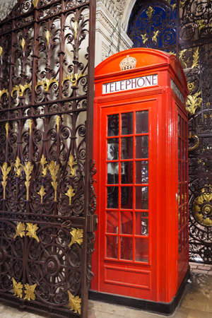 Popular tourist Red phone booth in night lights illumination in London, England, United Kingdomの写真素材