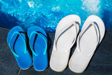 Beach slippers on border of a swimming pool - holiday tropical conceptの写真素材