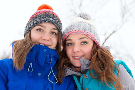 Pretty young winter women have fun outdoorsの写真素材