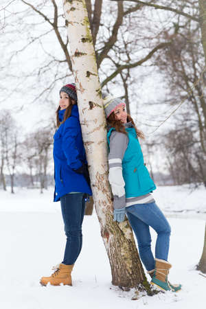 Pretty young winter women have fun outdoorsの写真素材