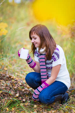 Pretty woman in a bright colorful autumn parkの写真素材