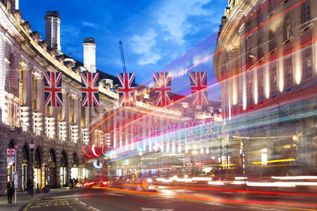 United Kingdom, England, London - 2016 June 17: Popular tourist Regent street with flags union jack in night lights illuminationのeditorial素材