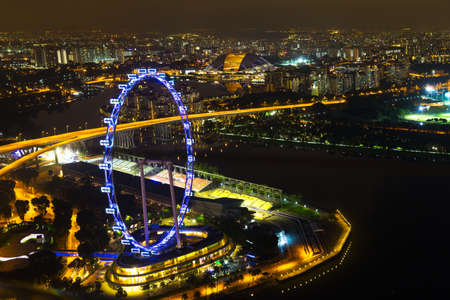 Singapore, 15 January 2016 - Landscape of the Singapore Marina Bay wheel in night lights from skypark obsevation deckのeditorial素材