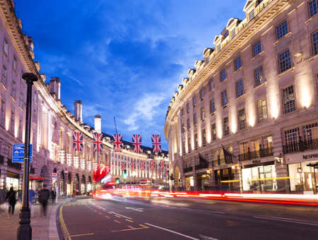 United Kingdom, England, London - 2016 June 17: Popular tourist Regent street with flags union jack in night lights illuminationのeditorial素材