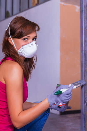 young beautiful woman paints with silver paint brushの写真素材