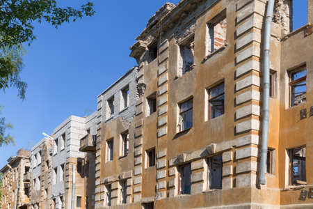 Abandoned building - broken tenement apartment house in daylightの写真素材