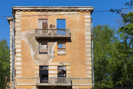 Abandoned building - broken tenement apartment house in daylightの写真素材