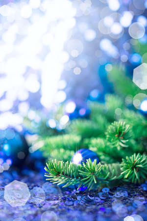Blue Christmas bauble with pine on a sparkling backgroundの写真素材