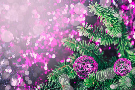 Purple Christmas bauble with pine on a sparkling backgroundの写真素材