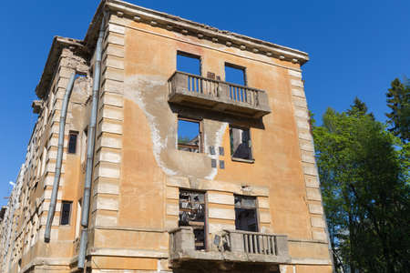 Abandoned building - broken tenement apartment house in daylightの写真素材