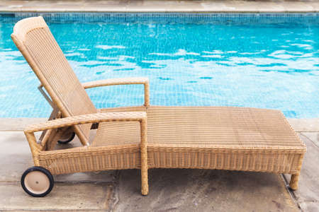 the sun lounger by the blue pool