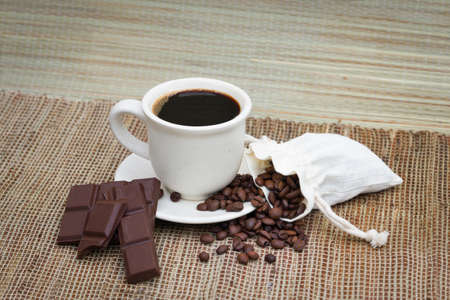 Coffee with beans and chocolate on a whiteの写真素材