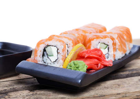 Salmon sushi rolls on a wooden backgroundの写真素材