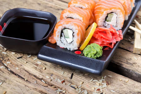 Salmon sushi rolls on a wooden backgroundの写真素材