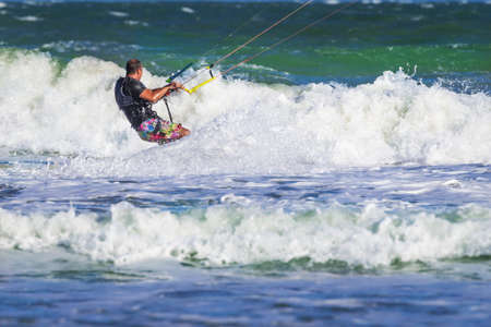 Young atletic man riding kite surf on a sea in Vietnamの写真素材