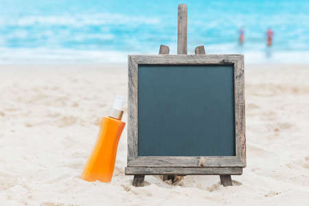 Chalk board sunscreen cream sand beach tropicの写真素材