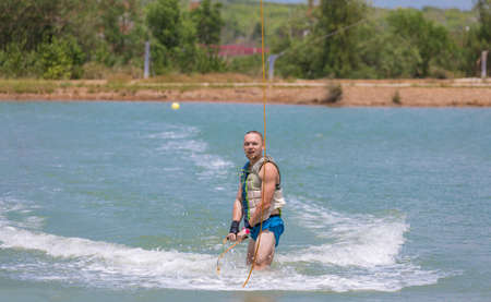 Man study wakeboarding on a blue lake summer sportsの写真素材