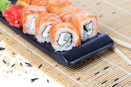 Salmon sushi rolls on a wooden backgroundの写真素材