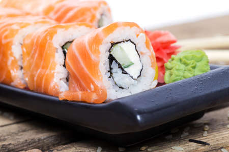 Salmon sushi rolls on a wooden backgroundの写真素材