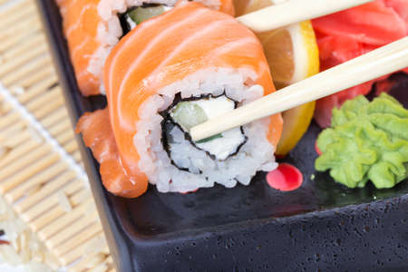 Salmon sushi rolls on a wooden backgroundの写真素材