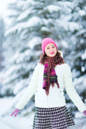 Happy winter women in park snow and Christmas lightsの写真素材