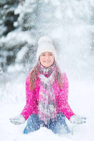 Happy winter women in park snow and Christmas lightsの写真素材