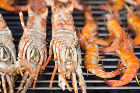 Fresh large prawns shrimps on barbecue outdoorsの写真素材