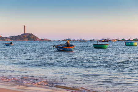Vietnam Mui Ne village fishing boats and ships in sunset lightの写真素材