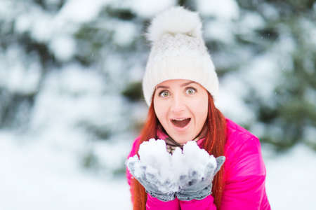 Happy winter women in park snow and Christmas lightsの写真素材