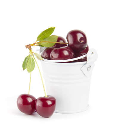 Sweet cherry berries in busket on white backgroundの写真素材