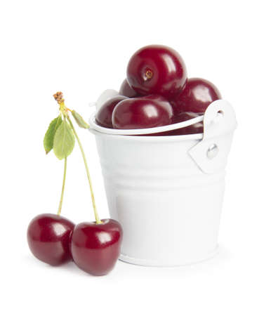 Sweet cherry berries in busket on white backgroundの写真素材