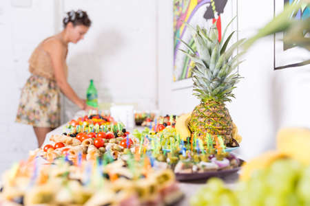 Young pretty woman housewife cooking with curlers on hairの写真素材