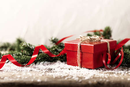Red present gift box on wooden background Christmas New Year compositionの写真素材