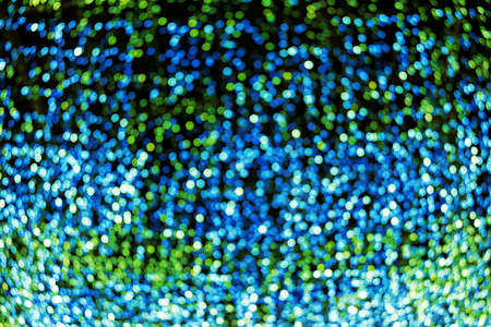 Blur bokeh green unfocused Christmas lights textured backgroundの写真素材