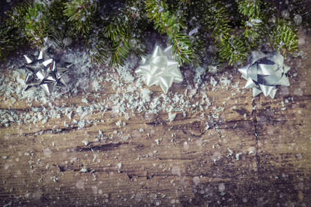 Packaging bows with Christmas tree on wooden backgroundの写真素材
