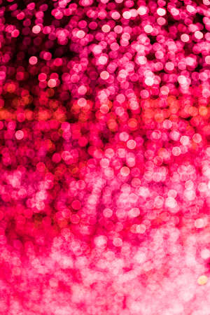 Blur bokeh red unfocused Christmas lights textured backgroundの写真素材