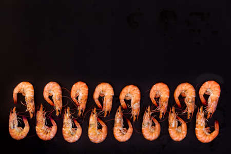 Perfect cooked prawns shrimps and text space note book top view flat lay layoutの写真素材