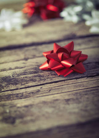 Present gift packaging bows on wooden background Christmas New Year compositionの写真素材