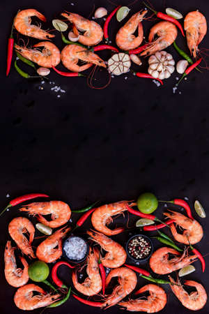 Perfect cooked prawns shrimps with herbs, spices and text space note book top view flat lay layoutの写真素材