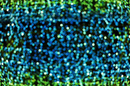 Blur bokeh green unfocused Christmas lights textured backgroundの写真素材