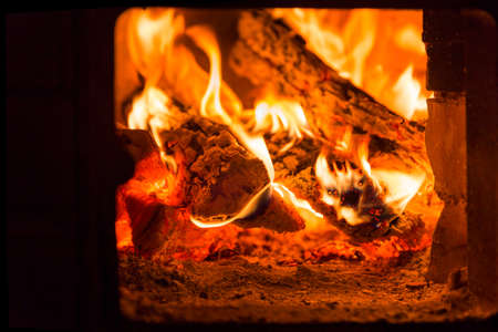 Fire and coals in brick fireplace furnaceの写真素材