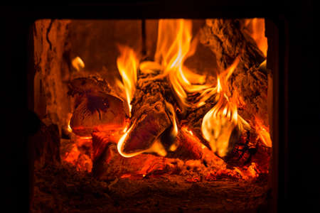 Fire and coals in brick fireplace furnaceの写真素材