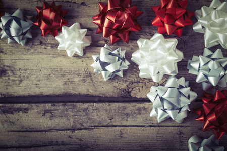 Present gift packaging bows on wooden background Christmas New Year compositionの写真素材