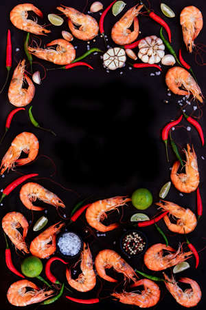 Perfect cooked prawns shrimps with herbs, spices and text space note book top view flat lay LAYOUTの写真素材
