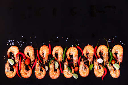 Perfect cooked prawns shrimps with herbs, spices and text space note book top view flat lay LAYOUTの写真素材