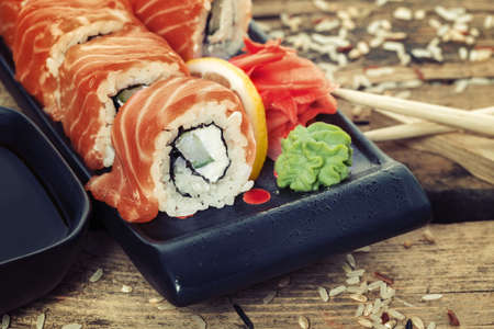 Salmon sushi rolls on a wooden backgroundの写真素材